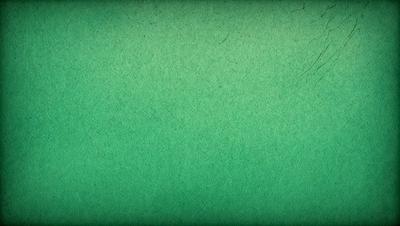 The primary subject of the image is a green background. The setting is a green wall, and the visual style is a photo. The colors and mood of the image are predominantly green, creating a calm and soothing atmosphere.