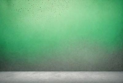 The primary subject of the image is a green wall with a mottled texture. The setting is a room with a concrete floor. The visual style is a close-up of the green wall, which gives the impression of a textured surface. The colors and mood of the image are predominantly green, creating a calm and soothing atmosphere.