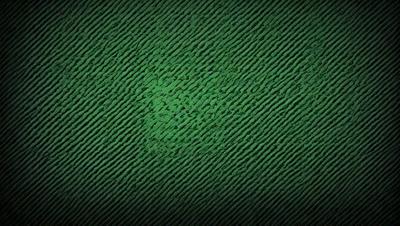 The primary subject of the image is a green, patterned surface. The setting appears to be a dark room, with the green patterned surface being the main focus. The visual style of the image is a close-up of the green patterned surface, which gives it a digital art or illustration appearance. The colors and mood of the image are predominantly green, creating a calm and soothing atmosphere.