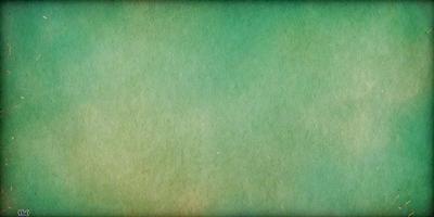 The primary subject of the image is a large, green, textured surface. The setting is a bright, open sky, which serves as the background. The visual style is a combination of a photo and a digital art, creating a unique and interesting appearance. The colors are predominantly green, with some blue and white accents, giving the image a calm and serene atmosphere.