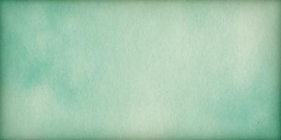 The primary subject of the image is a large, empty white space. The setting is a green background, which creates a contrast with the white space. The visual style is a simple, clean, and minimalist design. The colors and mood of the image are predominantly green, which gives it a calm and serene atmosphere.