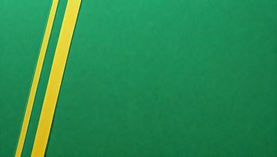 The primary subject of the image is a green background with a yellow line. The setting is a plain green surface, and the visual style appears to be a photo. The colors and mood of the image are predominantly green and calm, creating a serene atmosphere.