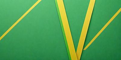 The primary subject of the image is a green and yellow striped paper. The setting is a green background, and the visual style appears to be a digital art or illustration. The colors and mood of the image are vibrant and lively, with the green and yellow stripes creating a sense of energy and movement.