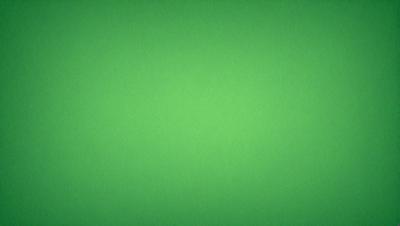 The primary subject of the image is a large, bright green wall. The setting is a plain, empty room with no other objects or people visible. The visual style is a close-up of the green wall, which gives a sense of depth and texture to the image. The colors and mood are predominantly green, creating a calm and serene atmosphere.