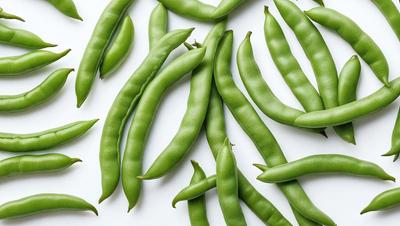 The primary subject of the image is a large group of green beans, which are the main objects in the scene. The beans are displayed on a white surface, which serves as the background. The visual style of the image is a close-up of the green beans, showcasing their vibrant color and texture. The overall atmosphere of the image is fresh and healthy, as the green beans are a common and nutritious vegetable.