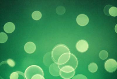 The primary subject of the image is a green background with a pattern of green and white lights. The setting appears to be a dark room, and the visual style is a digital art or illustration. The dominant colors are green and white, creating a calm and soothing atmosphere.