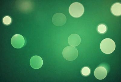 The primary subject of the image is a green background with a pattern of white lights. The setting appears to be a dark room, and the visual style is a combination of a photo and digital art. The dominant colors are green and white, creating a calm and serene atmosphere.