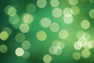 The primary subject of the image is a green background with a pattern of green and white lights. The setting appears to be a dark room, and the visual style is a close-up of the green and white lights. The colors and mood of the image are predominantly green and white, creating a calm and serene atmosphere.