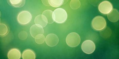 The primary subject of the image is a green background with a pattern of bright, glowing circles. The setting appears to be a brightly lit environment, possibly a room with a green wall. The visual style of the image is a combination of a photo and digital art, creating a unique and eye-catching pattern. The dominant colors in the image are green and the bright, glowing circles, which contribute to a lively and energetic atmosphere.