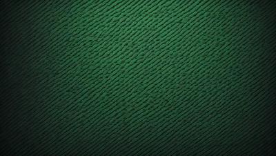 The primary subject of the image is a green, patterned surface. The setting appears to be a wall or a piece of fabric with a unique design. The visual style of the image is a close-up of the pattern, which gives a sense of depth and texture to the surface. The colors in the image are predominantly green, creating a calm and soothing atmosphere.