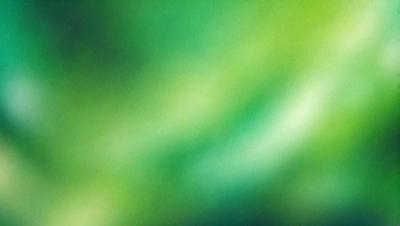 The primary subject of the image is a close-up of a green, leafy plant. The setting is a bright, sunny day, and the visual style is a natural, outdoor environment. The colors and mood of the image are predominantly green, with a lively and vibrant atmosphere.