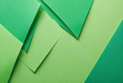 The primary subject of the image is a green paper, which is the main object, scene, or focus of the image. The setting is a green background, which provides a contrasting color to the green paper. The visual style of the image is a close-up of the green paper, showcasing its texture and details. The colors and mood of the image are predominantly green, creating a calm and soothing atmosphere.