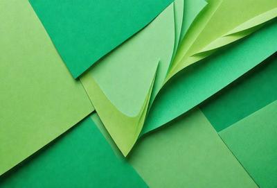 The primary subject of the image is a green paper, which is the main object, scene, or focus of the image. The setting is a green background, and the visual style is a photo. The colors and mood of the image are predominantly green, creating a calm and serene atmosphere.