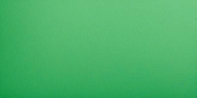 The primary subject of the image is a large, bright green surface. The setting is a plain, empty room with no visible objects or people. The visual style is a close-up of the green surface, which appears to be a piece of paper or a wall. The colors and mood of the image are predominantly green, creating a calm and serene atmosphere.