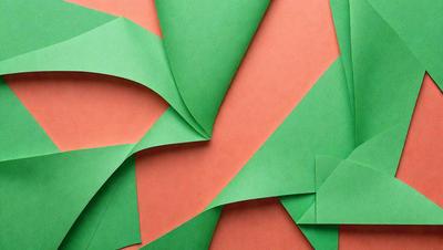 The primary subject of the image is a green and red paper, which is the main object, scene, or focus of the image. The setting is a close-up of the paper, showcasing its texture and colors. The visual style is a combination of digital art and illustration, as the paper appears to be a digital creation. The dominant colors are green and red, creating a lively and vibrant atmosphere.