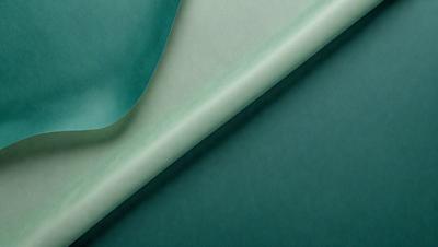 The primary subject of the image is a green sheet of fabric. The setting is a dark room, and the visual style appears to be a photo. The colors and mood of the image are predominantly dark and moody, with the green fabric being the main focal point.