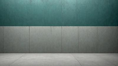 The primary subject of the image is a large, grey wall. The setting is a room with a concrete floor. The visual style is a photo, and the dominant colors are grey and blue. The overall atmosphere is minimalistic and industrial.