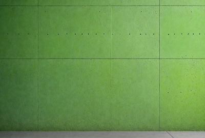 The primary subject of the image is a green wall with a row of holes in it. The setting is a room with a green wall, and the visual style is a photo. The dominant colors are green, and the overall atmosphere is calm and serene.