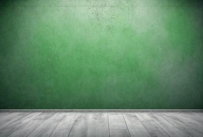 The primary subject of the image is a green wall with a white baseboard. The setting is a room with a green wall, and the visual style is a photo. The dominant colors are green and white, creating a calm and soothing atmosphere.