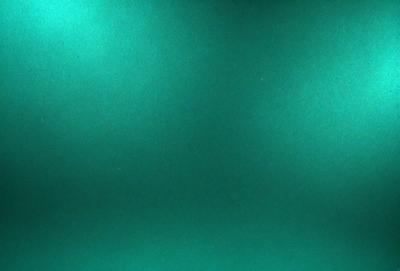 The primary subject of the image is a green background. The setting is a dark room, and the visual style appears to be a photo. The colors and mood of the image are predominantly green, creating a calm and serene atmosphere.
