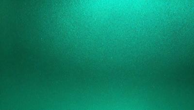 The primary subject of the image is a green surface, which appears to be a wall or a piece of artwork. The setting is indoors, and the visual style is a close-up of the green surface. The colors and mood of the image are predominantly green, creating a calm and serene atmosphere.