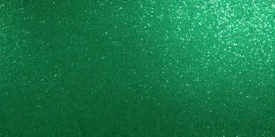 The primary subject of the image is a green background with a pattern of glittering stars. The setting is a dark room, and the visual style appears to be a digital art or illustration. The dominant colors are green and white, creating a calm and serene atmosphere.