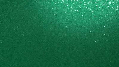 The primary subject of the image is a green background with a pattern of glittering stars. The setting is a dark room, and the visual style appears to be a digital art or illustration. The dominant colors are green and white, creating a calm and serene atmosphere.