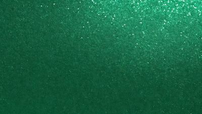 The primary subject of the image is a green background with a pattern of glittering stars. The setting is a dark room, and the visual style appears to be a digital art or illustration. The dominant colors are green and black, creating a mood of mystery and intrigue.