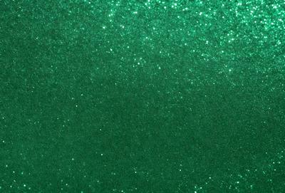 The primary subject of the image is a green background with a pattern of glittering stars. The setting is a dark room, and the visual style appears to be a digital art or illustration. The dominant colors are green and silver, creating a calm and serene atmosphere.