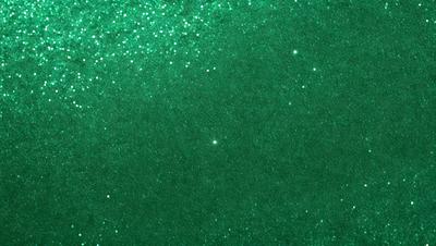 The primary subject of the image is a green background with a pattern of stars. The setting appears to be a dark, starry night, with the green background providing a contrasting backdrop. The visual style of the image is a combination of a photo and digital art, creating a unique and captivating atmosphere. The dominant colors in the image are green and black, with the green background and the stars creating a sense of depth and intrigue.