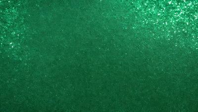 The primary subject of the image is a close-up of a green surface, possibly a wall or a piece of fabric. The setting appears to be indoors, with the green surface being the main focus of the image. The visual style is a close-up, which emphasizes the details of the green surface. The colors and mood of the image are predominantly green, creating a calm and soothing atmosphere.