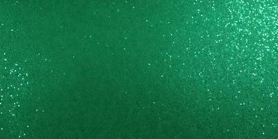 The primary subject of the image is a green background with glittering stars. The setting is a dark background, and the visual style appears to be a digital art or illustration. The colors are predominantly green, and the overall atmosphere is bright and lively.