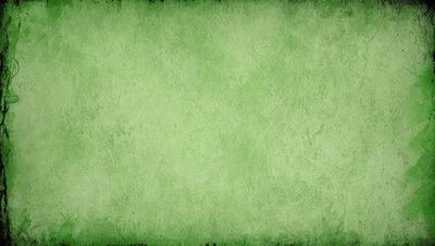 The primary subject of the image is a green wall with a textured surface. The setting is a room with a green wall, and the visual style is a close-up of the wall. The colors and mood of the image are predominantly green, creating a calm and soothing atmosphere.