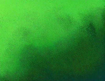 The primary subject of the image is a close-up of a green background with a pattern of green and white dots. The setting appears to be a digital art or illustration, as the background is composed of a repeating pattern of dots. The visual style gives the image a vibrant and lively atmosphere, with the green and white dots creating a sense of depth and texture.