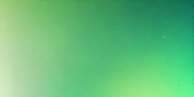 The primary subject of the image is a large, bright green wall. The setting is a dark room, and the visual style is a photo. The dominant colors are green, and the overall atmosphere is calm and serene.