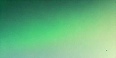 The primary subject of the image is a large, bright green background. The setting is a dark, empty space, with no visible objects or people. The visual style is a close-up of the green background, which creates a sense of depth and focus. The colors and mood of the image are predominantly green, which gives it a calm and serene atmosphere.