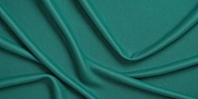 The primary subject of the image is a close-up of a green fabric, possibly a piece of cloth or a curtain. The setting is a dark background, which contrasts with the green fabric. The visual style appears to be a photo, as the fabric is captured in detail. The colors and mood of the image are predominantly green, creating a calm and soothing atmosphere.