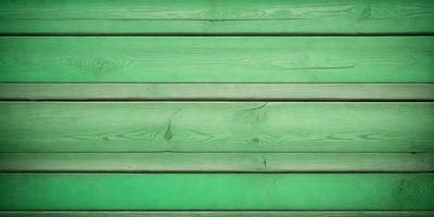 The primary subject of the image is a green wooden wall. The setting is a green wall, and the visual style is a photo. The dominant colors are green, and the overall atmosphere is calm and serene.