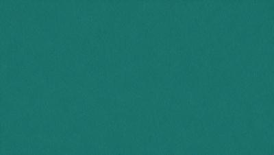 The primary subject of the image is a large, dark blue surface. The setting is a room with a green background. The visual style is a close-up of the blue surface, which appears to be a wall or a table. The colors and mood of the image are predominantly dark and moody, with the blue surface being the main focus.