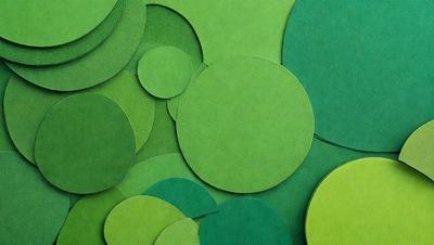The primary subject of the image is a collection of green circles, which are arranged in various sizes and shapes. The setting is a green background, which creates a cohesive and visually appealing environment. The visual style of the image is a combination of photo and digital art, as the green circles are arranged in a pattern that resembles a collage. The dominant colors in the image are green, which creates a calm and soothing atmosphere.