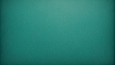 The primary subject of the image is a large, empty, and dark blue wall. The setting is a room with a green background, which creates a contrasting effect. The visual style is a close-up of the wall, showcasing its texture and color. The dominant colors are blue and green, giving the image a calm and serene atmosphere.
