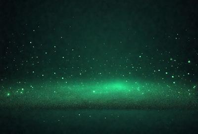The primary subject of the image is a green background with a starry pattern. The setting is a dark, starry night, and the visual style is a combination of a photo and digital art. The colors are predominantly green, and the overall atmosphere is serene and peaceful.