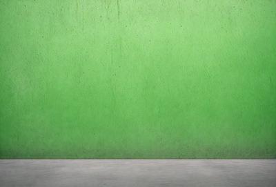 The primary subject of the image is a green wall. The setting is a concrete wall, and the visual style is a photo. The dominant colors are green, and the overall atmosphere is calm and serene.