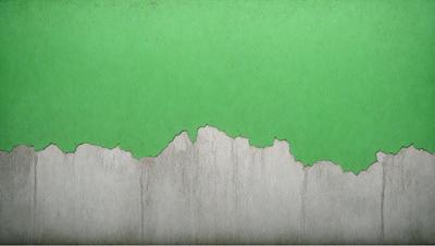 The primary subject of the image is a green wall with a white, peeling paint surface. The setting is a room with a green background. The visual style is a photo, and the colors and mood are predominantly green and somewhat dull.