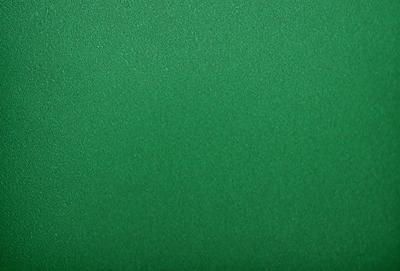 The primary subject of the image is a large, green wall. The setting is a room with a green background, which creates a vibrant and lively atmosphere. The visual style is a close-up of the green wall, showcasing its texture and color. The dominant colors are green, which creates a sense of freshness and energy.