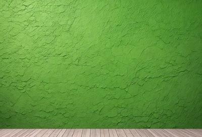 The primary subject of the image is a green wall with a textured surface. The setting is a room with a wooden floor. The visual style is a photo of a green wall with a textured surface. The dominant colors are green and the overall atmosphere is calm and serene.