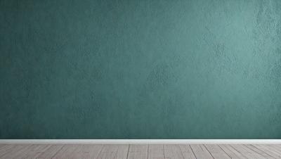 The primary subject of the image is a wall painted in a light blue color. The setting is a room with a wooden floor. The visual style is a photo, and the colors and mood are calm and soothing.