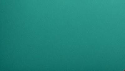 The primary subject of the image is a large, bright green surface. The setting is a dark background, which contrasts with the vibrant green color of the surface. The visual style appears to be a photo, as the image is in focus and the colors are natural. The dominant colors are green and dark, creating a calm and serene atmosphere.