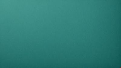 The primary subject of the image is a large, empty, and bright blue surface. The setting is a brightly colored, blue-green background. The visual style is a close-up of the blue surface, which gives a sense of depth and dimension. The colors and mood of the image are vibrant and lively, with the blue surface and green background creating a sense of freshness and energy.