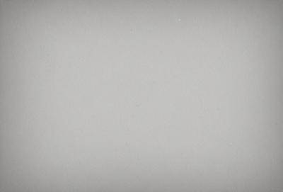 The primary subject of the image is a large, white wall. The setting is a plain, empty room with no other objects or people visible. The visual style is a simple, clean, and minimalist design. The colors and mood are predominantly neutral, with a sense of emptiness and simplicity.